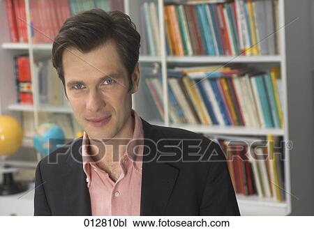 portrait of teacher in front of bookshelf View Large Photo Image Stock Image - portrait of teacher in front of bookshelf. Fotosearch