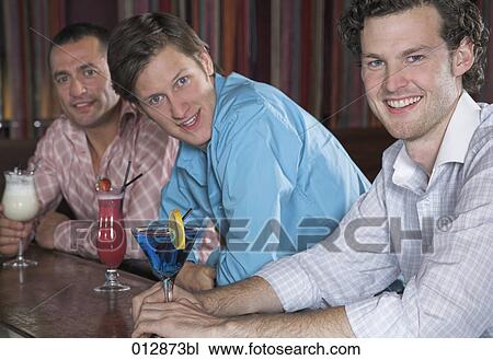 portrait of three male friends having cocktails at bar View Large Photo Image Stock Image - portrait of three male friends having cocktails at bar. Fotosearch