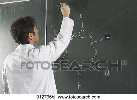 Stock Image - rear view of scientist writing chemical formula on blackboard. Fotosearch
