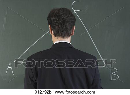 rear view of teacher looking at drawing of triangle on blackboard View Large Photo Image Stock Image - rear view of teacher looking at drawing of triangle on blackboard. Fotosearch