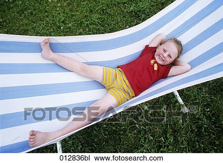 smiling young girl lying on sunlounger View Large Photo Image Stock Image - smiling young girl lying on sunlounger. Fotosearch