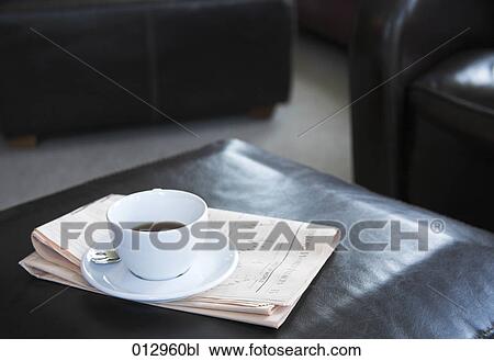 Stock Image - still life of coffee cup and business newspaper. Fotosearch