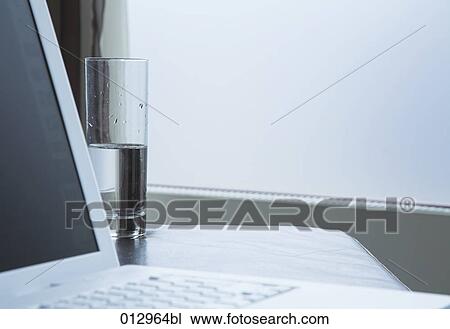 still life of laptop computer and glass of water View Large Photo Image Stock Image - still life of laptop computer and glass of water. Fotosearch