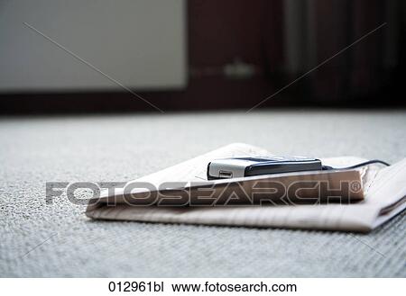 still life of mobile lying on business paper on the floor View Large Photo Image Stock Image - still life of mobile lying on business paper on the floor. Fotosearch