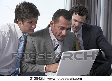 Stock Image - three businessmen working together. Fotosearch