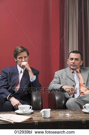 Stock Image - two businessmen having a break. Fotosearch
