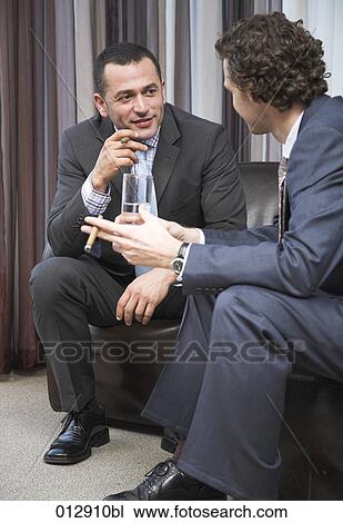 Stock Image - two businessmen having a conversation . Fotosearch