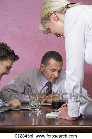 waitress writing down orders from two guests in restaurant View Large Photo Image Stock Image - waitress writing down orders from two guests in restaurant. Fotosearch