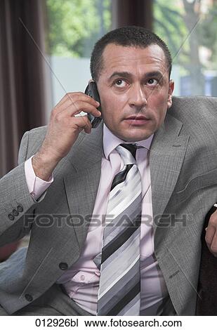 worried looking businessman listening on mobile phone View Large Photo Image Stock Image - worried looking businessman listening on mobile phone. Fotosearch