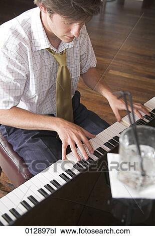 young man playing piano View Large Photo Image Stock Image - young man playing piano. Fotosearch