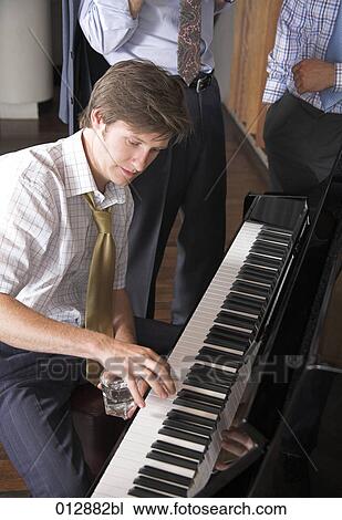 young man playing some notes on piano View Large Photo Image Stock Image - young man playing some notes on piano. Fotosearch