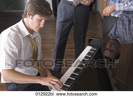young man with thoughtful expression playing piano View Large Photo Image Stock Image - young man with thoughtful expression playing piano. Fotosearch