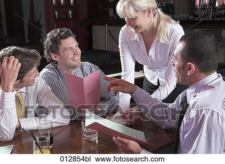 young waitress taking orders from three guests in restaurant View Large Photo Image Stock Image - young waitress taking orders from three guests in restaurant. Fotosearch