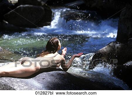 young woman refreshing herself in brook View Large Photo Image Stock Image - young woman refreshing herself in brook. Fotosearch