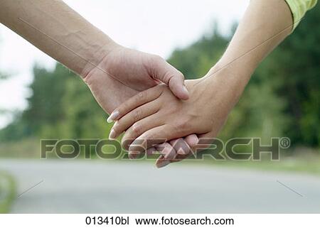 close-up of man and woman holding hands View Large Photo Image Stock Image - close-up of man and woman holding hands. Fotosearch