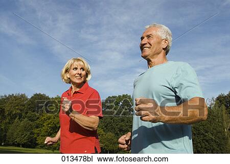 close-up of mature man and woman jogging View Large Photo Image Stock Image - close-up of mature man and woman jogging. Fotosearch