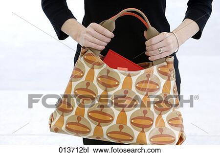 close-up of woman holding colourful handbag View Large Photo Image Stock Image - close-up of woman holding colourful handbag. Fotosearch