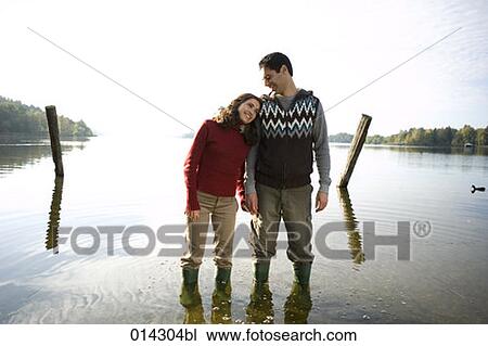 contented young couple standing in lake View Large Photo Image Stock Image - contented young couple standing in lake. Fotosearch