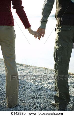 couple standing at lakeside holding hands View Large Photo Image Stock Image - couple standing at lakeside holding hands. Fotosearch