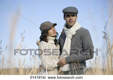 couple standing in reeds woman looking up to man View Large Photo Image Stock Image - couple standing in reeds woman looking up to man. Fotosearch