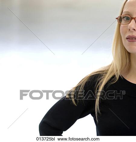 Stock Image - cropped portrait of young woman wearing spectacles. Fotosearch