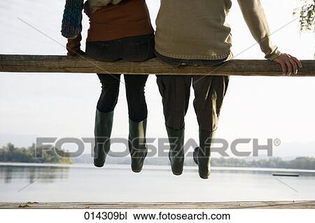 detail of couple in rubber boots sitting together at lakeside View Large Photo Image Stock Image - detail of couple in rubber boots sitting together at lakeside. Fotosearch