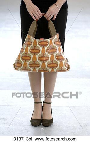 detail of woman holding colourful handbag View Large Photo Image Stock Image - detail of woman holding colourful handbag. Fotosearch