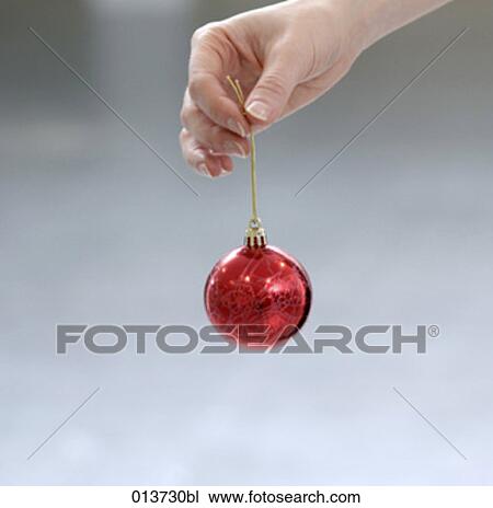 hand holding shiny red bauble View Large Photo Image Stock Image - hand holding shiny red bauble. Fotosearch