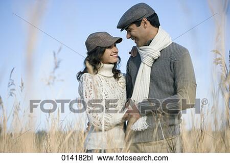 happy couple looking at each other in field View Large Photo Image Stock Image - happy couple looking at each other in field. Fotosearch