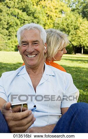 happy mature man listening to music in park View Large Photo Image Stock Image - happy mature man listening to music in park. Fotosearch