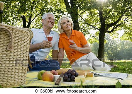Stock Image - harmonious couple having picnic. Fotosearch