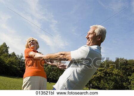 joyous couple dancing in park View Large Photo Image Stock Image - joyous couple dancing in park. Fotosearch