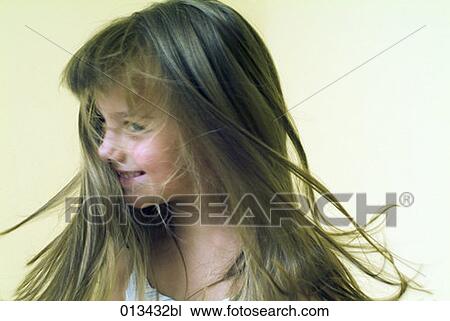 Stock Image - little girl waving her hair. Fotosearch