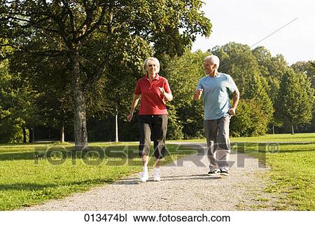 mature couple doing jogging exercises in park View Large Photo Image Stock Image - mature couple doing jogging exercises in park. Fotosearch