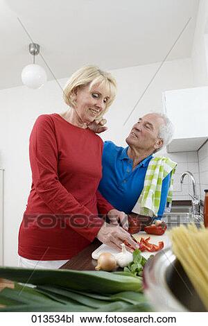 mature couple having a tender moment in kitchen View Large Photo Image Stock Image - mature couple having a tender moment in kitchen. Fotosearch
