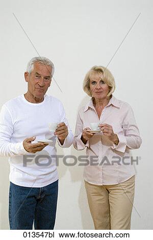 mature couple holding coffe cups View Large Photo Image Stock Image - mature couple holding coffe cups. Fotosearch