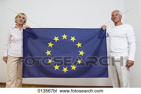 mature couple holding European Union flag View Large Photo Image Stock Image - mature couple holding European Union flag. Fotosearch