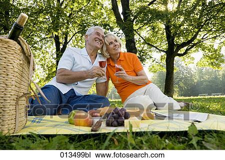 mature couple sharing a tender moment during picnic View Large Photo Image Stock Image - mature couple sharing a tender moment during picnic. Fotosearch