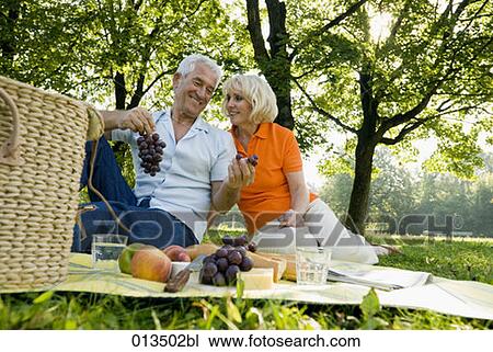mature couple sharing grapes at picnic View Large Photo Image Stock Image - mature couple sharing grapes at picnic. Fotosearch