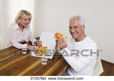 mature couple sharing pizza man smiling View Large Photo Image Stock Image - mature couple sharing pizza man smiling. Fotosearch