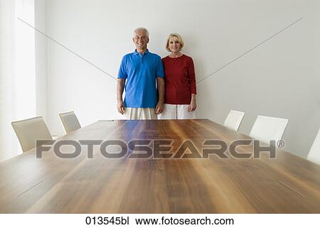 mature couple standing behind table View Large Photo Image Stock Image - mature couple standing behind table. Fotosearch