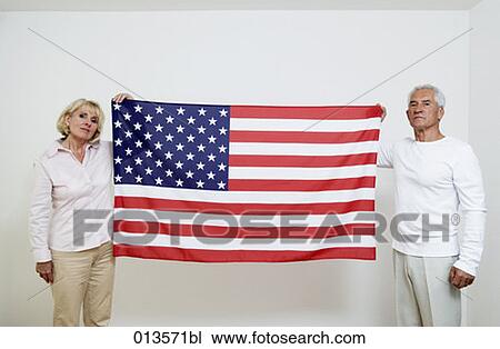 mature man and woman holding Star Spangled Banner View Large Photo Image Stock Image - mature man and woman holding Star Spangled Banner. Fotosearch