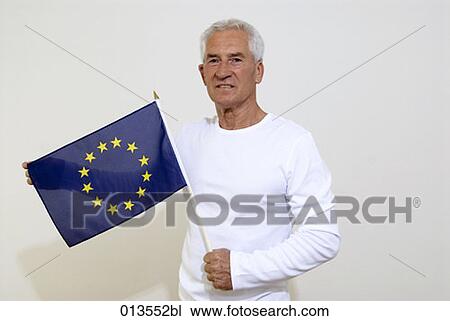 mature man holding flag of European Union View Large Photo Image Stock Image - mature man holding flag of European Union. Fotosearch
