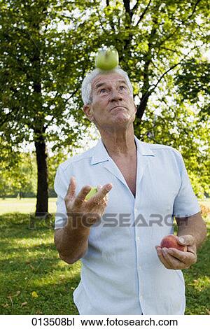 mature man juggling with fruit View Large Photo Image Stock Image - mature man juggling with fruit. Fotosearch
