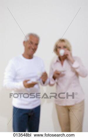 out of focus portrait of mature couple drinking coffee View Large Photo Image Stock Image - out of focus portrait of mature couple drinking coffee. Fotosearch