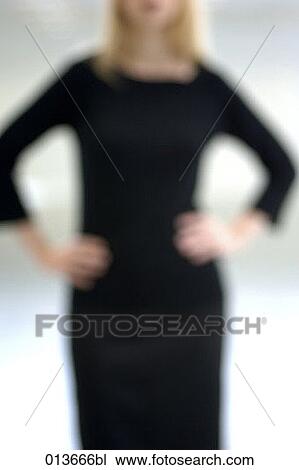 Stock Image - out of focus shape of young woman. Fotosearch