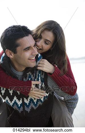 portrait of man carrying young woman piggyback View Large Photo Image Stock Image - portrait of man carrying young woman piggyback. Fotosearch