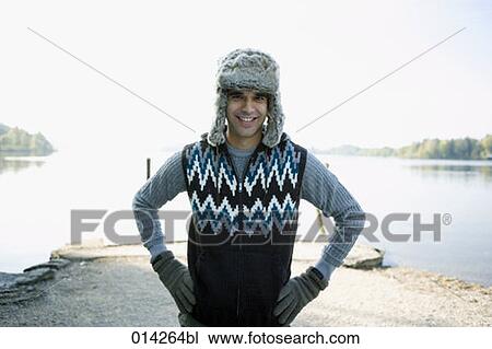 portrait of man standing at lake wearing fur hat and gloves View Large Photo Image Stock Image - portrait of man standing at lake wearing fur hat and gloves. Fotosearch