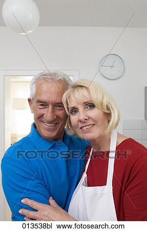 portrait of mature couple embracing in kitchen View Large Photo Image Stock Image - portrait of mature couple embracing in kitchen. Fotosearch