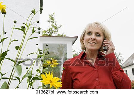 portrait of mature woman talking on mobile View Large Photo Image Stock Image - portrait of mature woman talking on mobile. Fotosearch